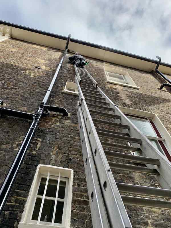Cleaning windows by hand in St. Johns Wood