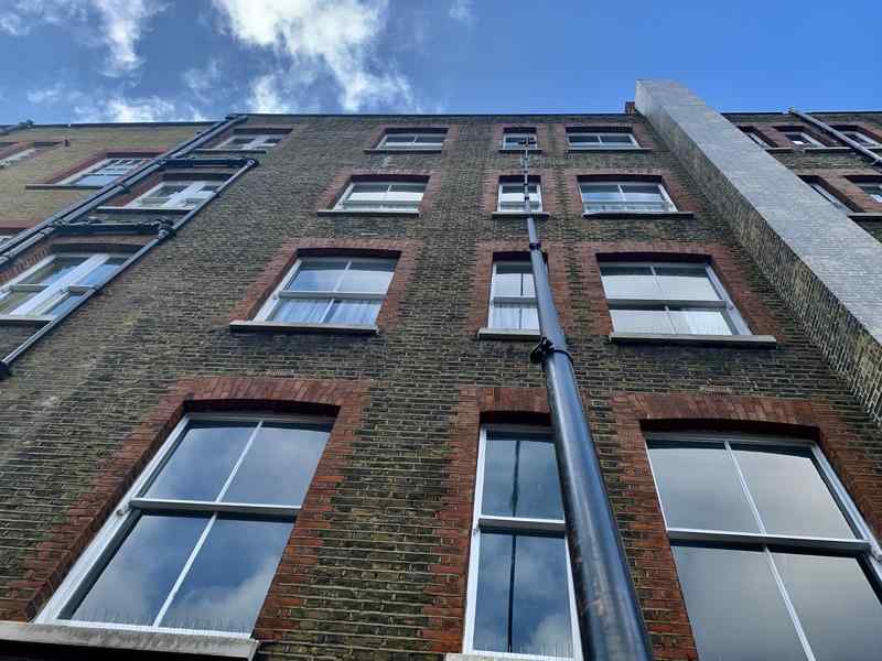 cleaning commercial property with water fed pole