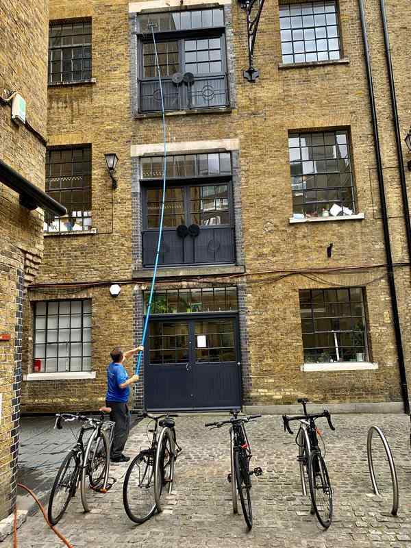 cleaning windows on a block of offices in Islington